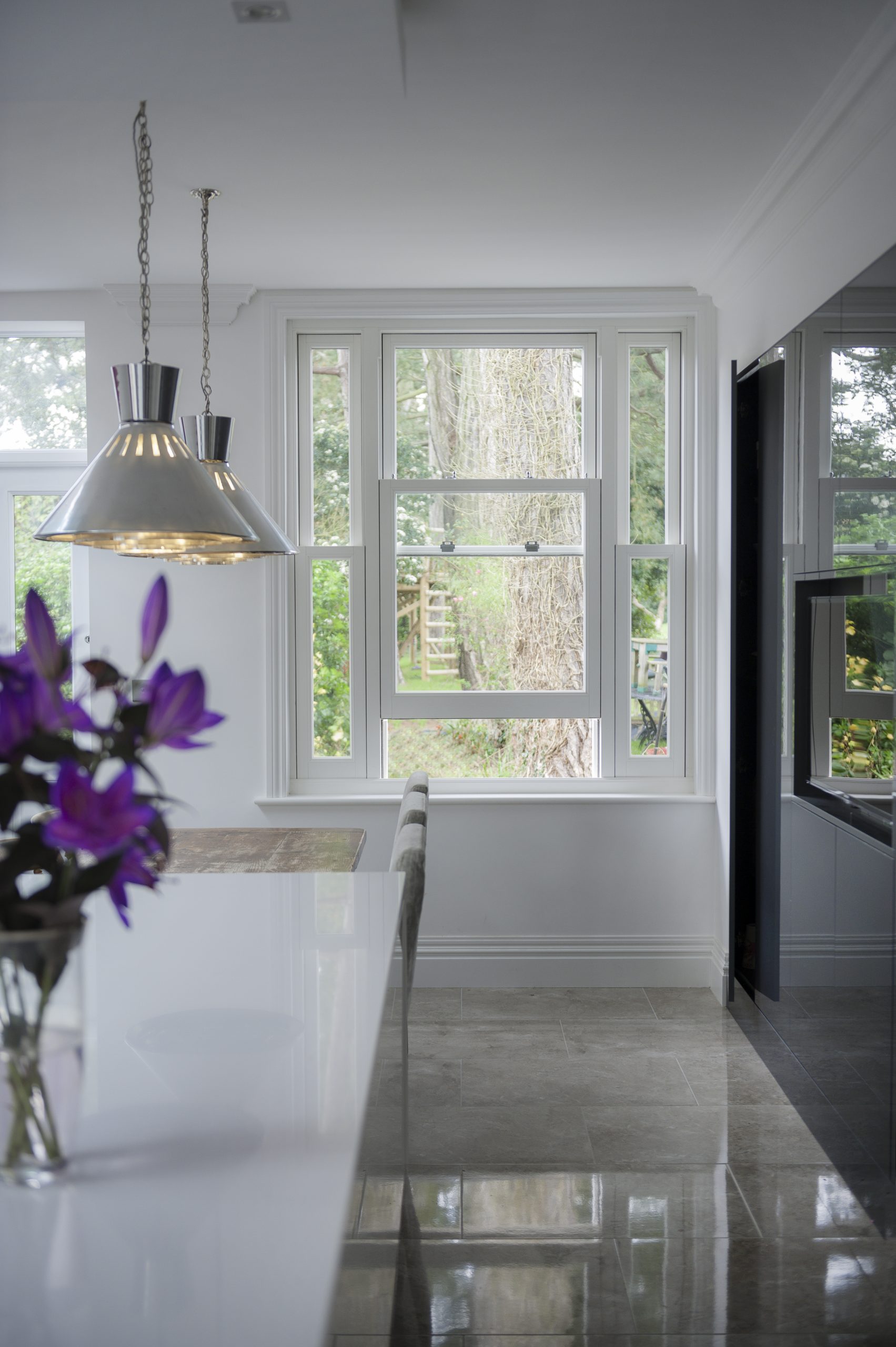 Slightly open white sash window in kitchen.